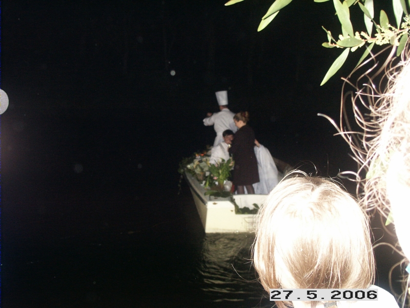 Wedding couple on a small boat on the pond